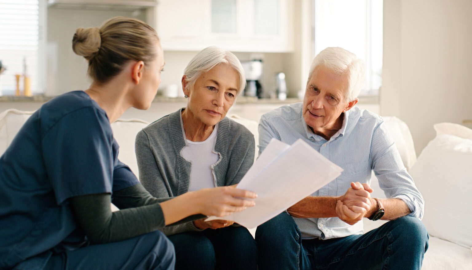 A nurse reviewing paperwork with a couple
