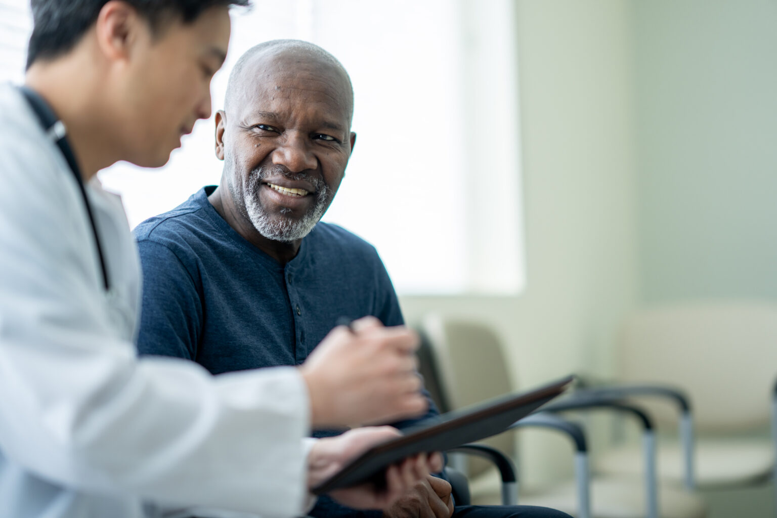 A clinician talking with an older patient