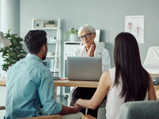 Doctor meeting with a couple at her desk